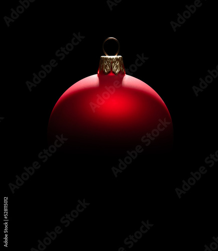 Red Christmas bauble isolated on black background