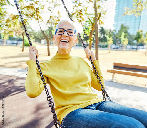 woman outdoor senior healthy exercise fit beautiful happy swing swinging fun leisure retirement elderly active vitality