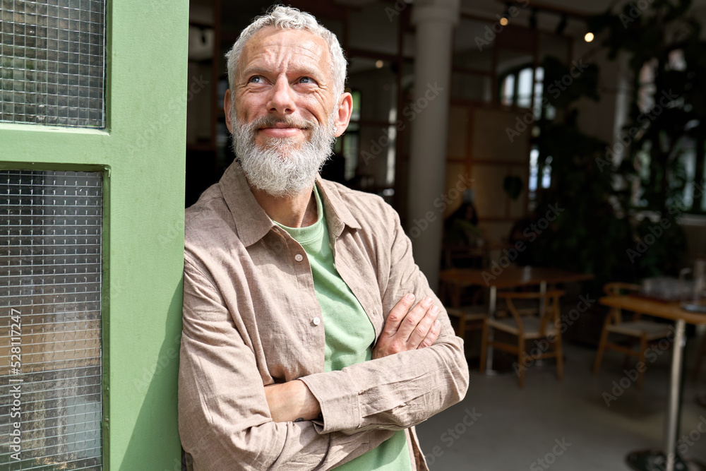 Happy smiling confident european middle aged older adult man small local business owner standing outside own cafe looking away and dreaming. Old senior entrepreneur portrait. Entrepreneurship - obrazy, fototapety, plakaty 