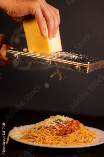 Fork holding spaghetti with tomato sauce