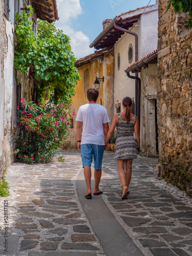 Young couple on romantic walk through picturesque alley of an old historic town © helivideo