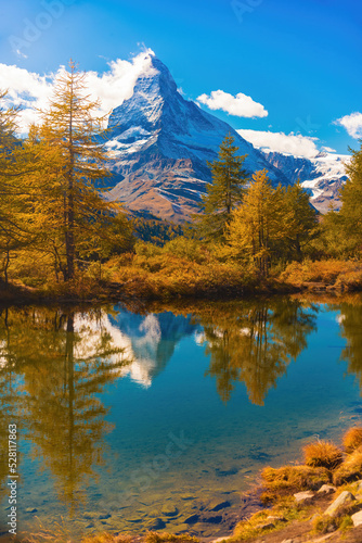 Autumn scenery with famous peak Matterhorn reflected in Grinjisee lake. Swiss Alps, Valais, Switzerland