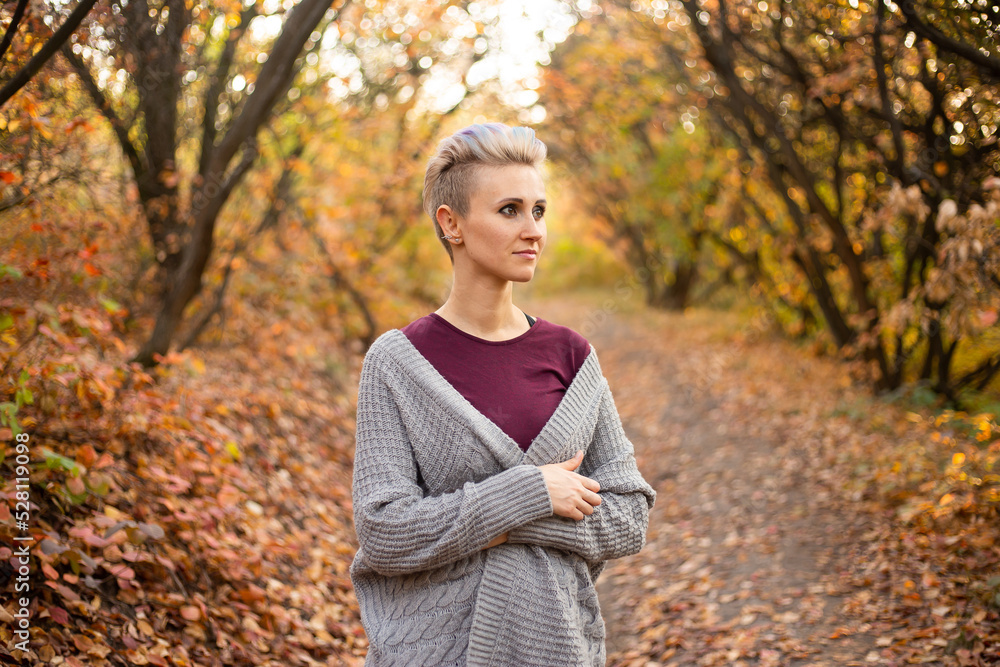 happy young woman in autumn forest background with golden and red trees happy young woman in autumn forest background with golden and red trees
