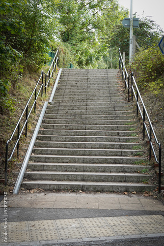 Fototapeta Naklejka Na Ścianę i Meble -  Concrete steps, stairs, with metal track or ramp for bicycles