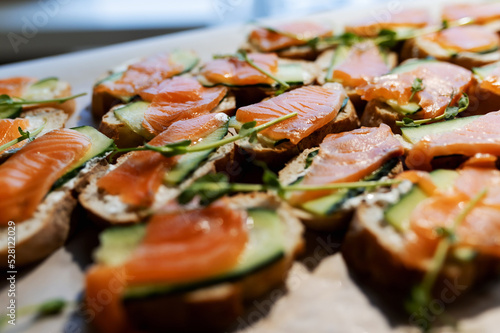 Healthy toasts with rye bread with cream cheese, salmon, fresh cucumber and red onion.