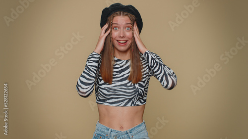 Oh my God, Wow. Excited amazed woman looking surprised at camera with big eyes, shocked by sudden victory game winning, lottery goal achievemen, good news. Adult girl on beige studio background indoor
