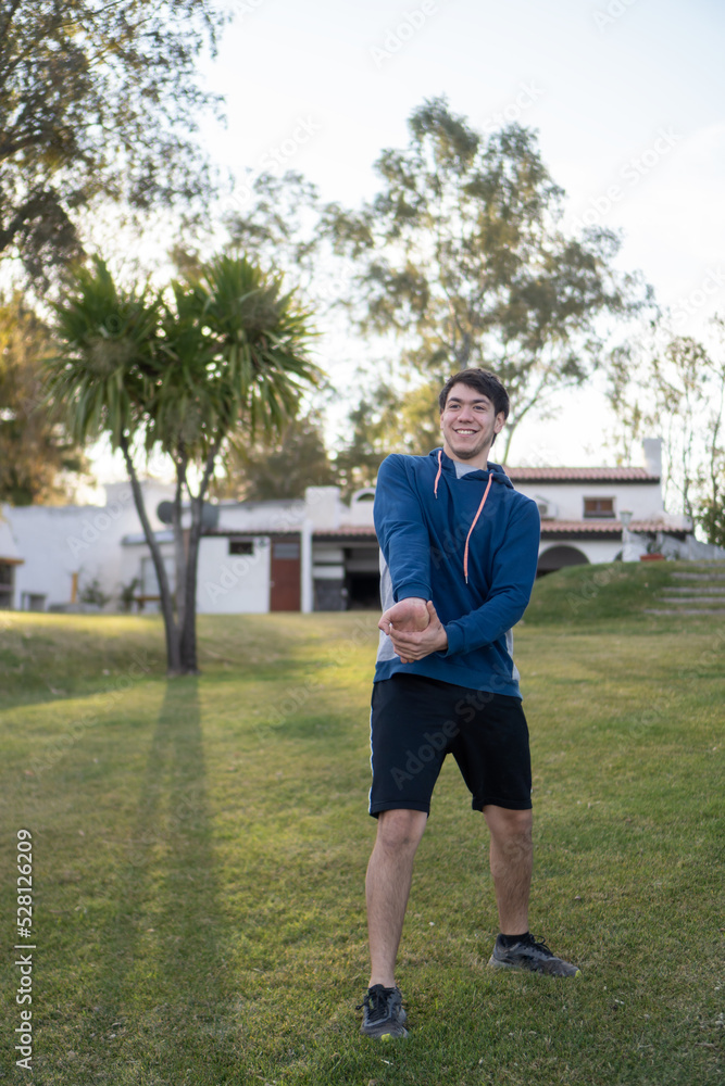 young man smiling while playing sports outdoors