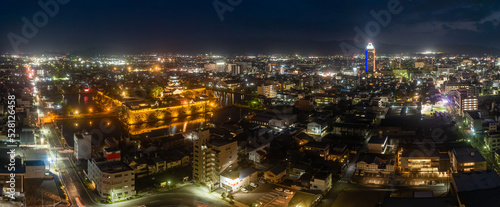 Panoramic aerial view of Imabari Castle and tower rising above city center at night © Osaze