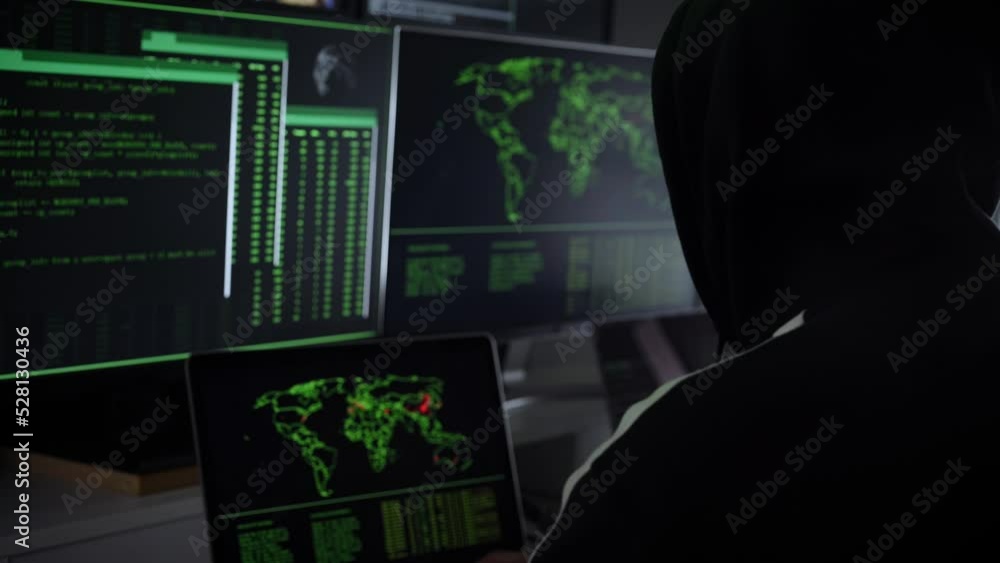 Criminal team Hacker using computer for organizing massive data breach attack on government and big company servers. Dark room surrounded computers Criminal team Hacker using computer for organizing massive data breach attack on government and big company servers. Dark room surrounded computers