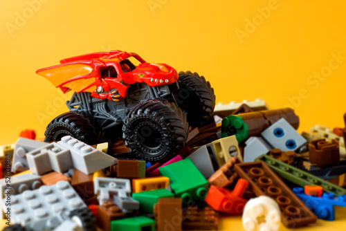 Fototapeta Naklejka Na Ścianę i Meble -  the monster car on the brick toy on orange background
