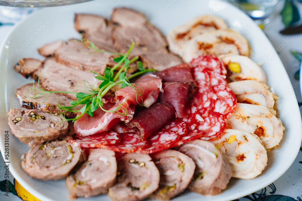 meat delicacies on a plate decorated with micro greens. meat delicacies on a plate decorated with micro greens.