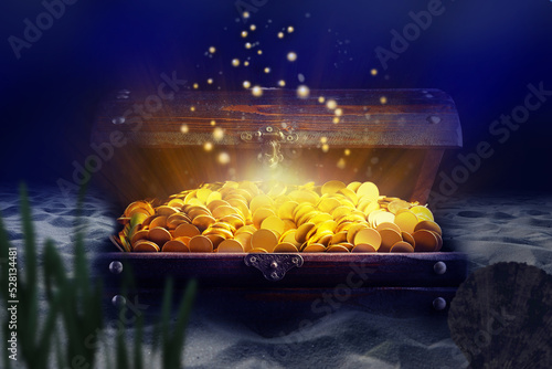 Open treasure chest with gold coins on sand seabed