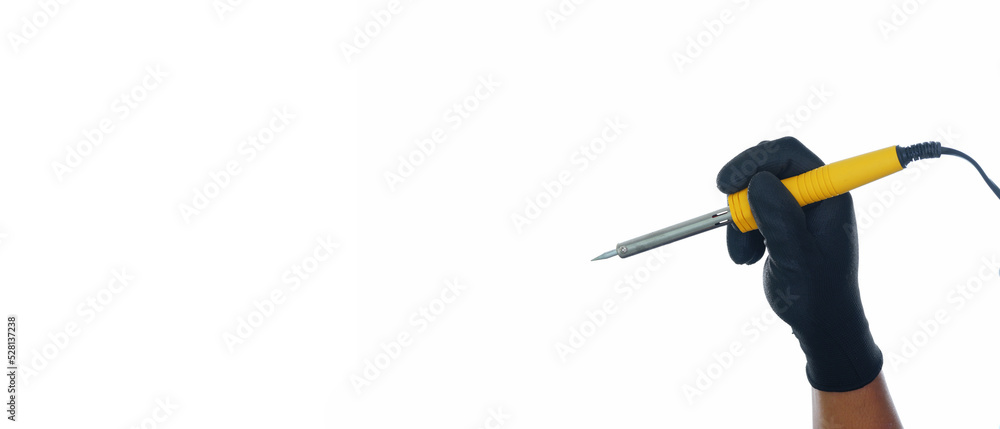 Hand wearing black gloves holding yellow soldering iron isolated white background with copy space Hand wearing black gloves holding yellow soldering iron isolated white background with copy space