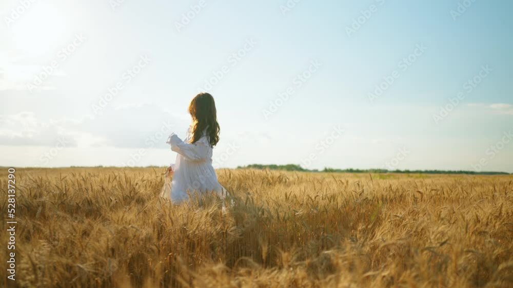 happy carefree woman is running alone on gold rye field in sunny summer day, slow motion shot happy carefree woman is running alone on gold rye field in sunny summer day, slow motion shot