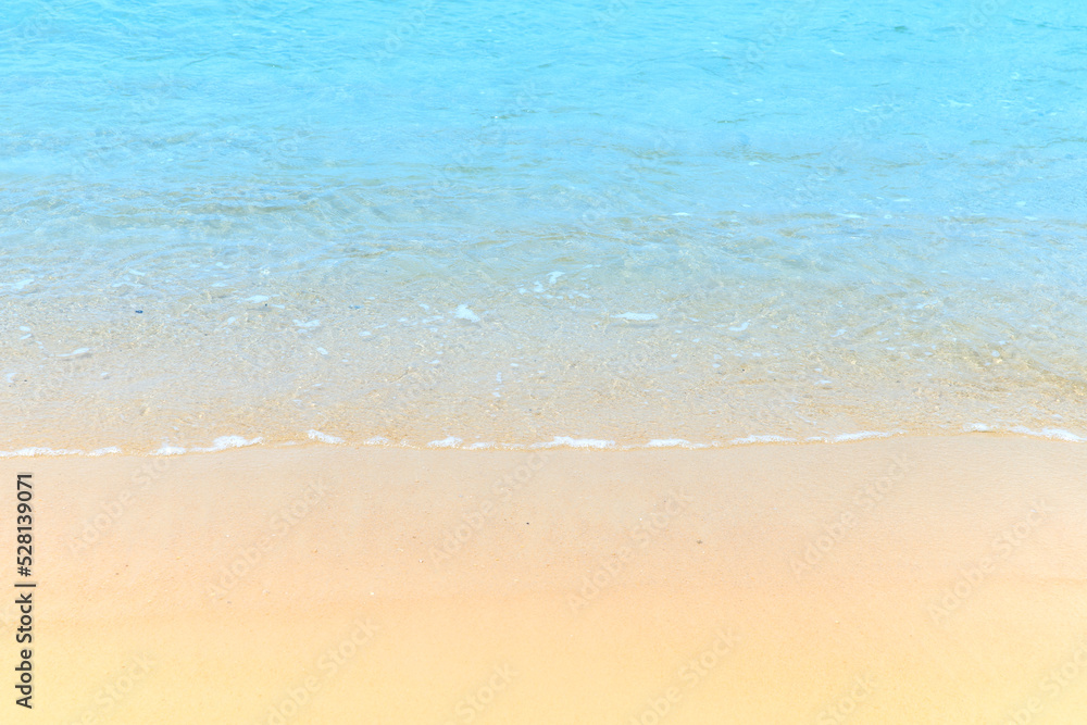 Soft blue ocean wave on clean sandy at the beach