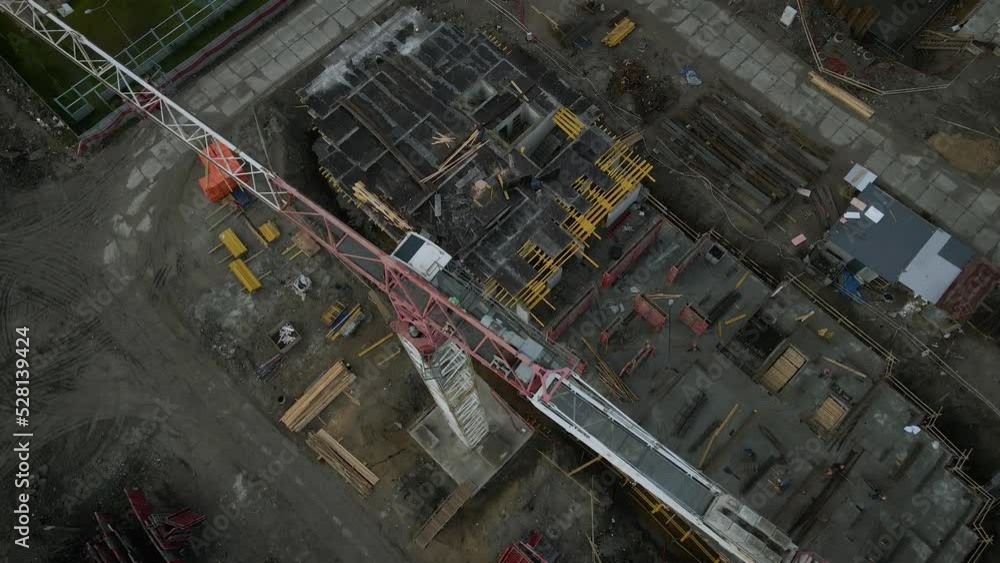 Aerial view of a constructing of residential high-rise buildings, cranes, steel, concrete, cargo, work next to park and highway in the St. Petersburg at sunny summer afternoon, shadows Aerial view of a constructing of residential high-rise buildings, cranes, steel, concrete, cargo, work next to park and highway in the St. Petersburg at sunny summer afternoon, shadows