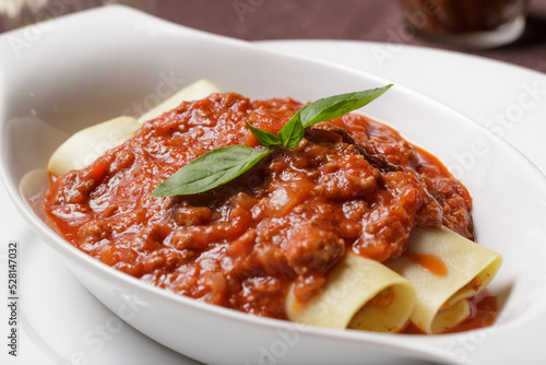 Delicious meat filled pasta on a plate. Italian cannelloni, Spanish cannelloni. - Image