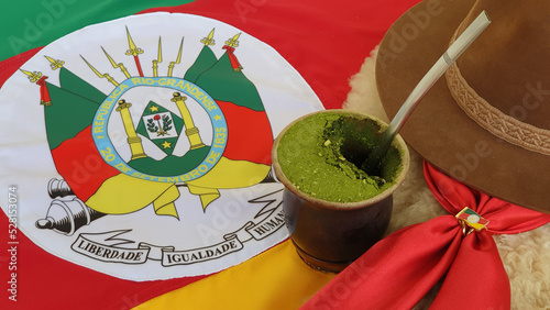 Chimarrão, hat and gaucho scarf over the Flag of the State of Rio Grande do Sul. photo