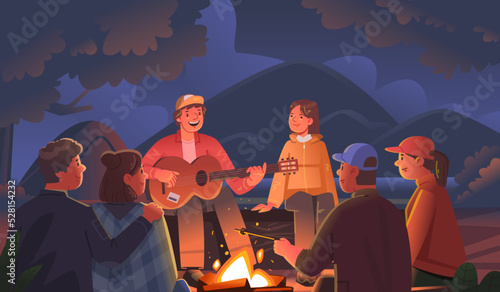 Camping. Happy friends are sitting around the campfire at night in a campground on a summer vacation