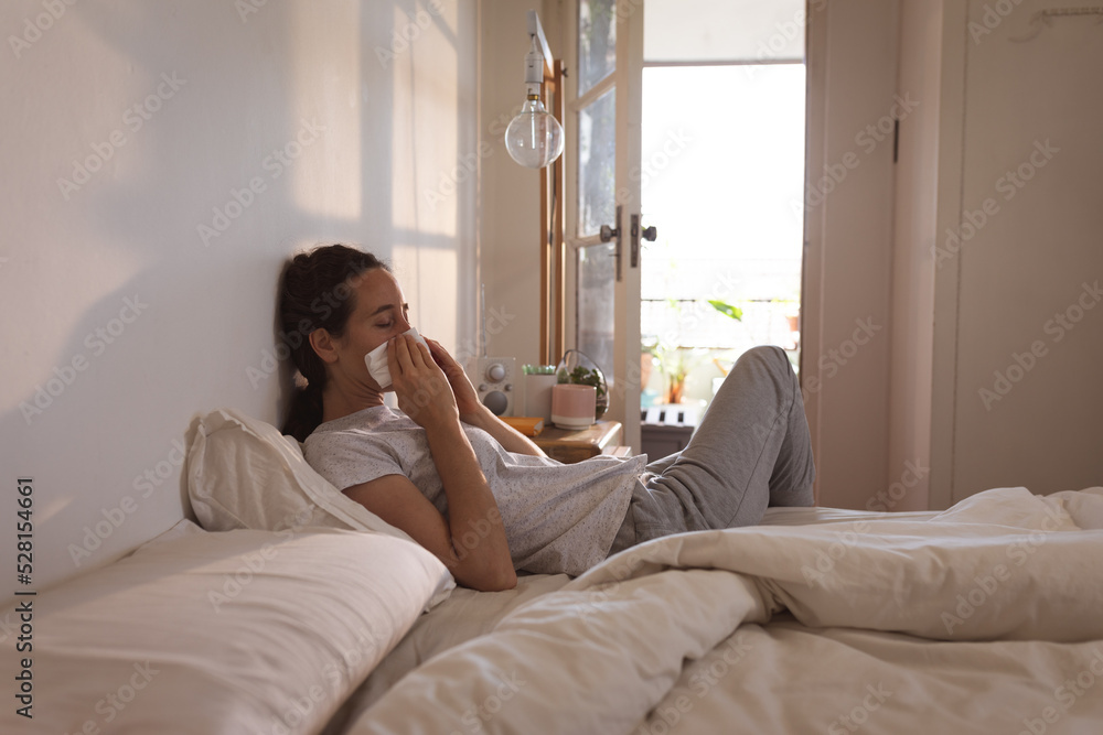 Sick Caucasian woman self isolating and social distancing in quarantine lockdown during coronavirus Sick Caucasian woman self isolating and social distancing in quarantine lockdown during coronavirus