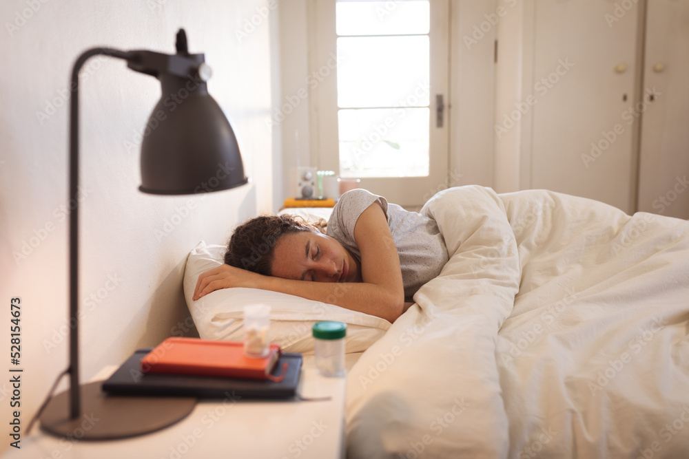 Sick Caucasian woman self isolating and social distancing in quarantine lockdown during coronavirus Sick Caucasian woman self isolating and social distancing in quarantine lockdown during coronavirus