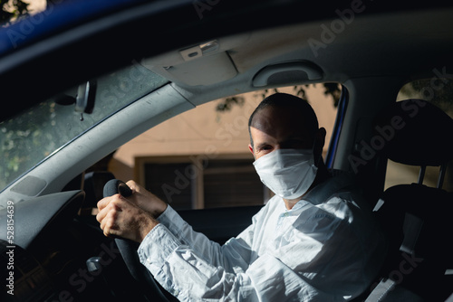 Caucasian man sitting in a car wearing a coronavirus covid19 mask