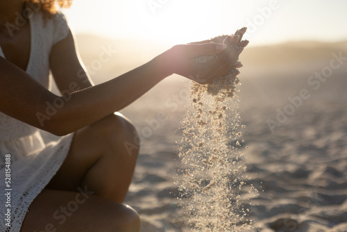 A mixed race woman enjoying free time on beach on a sunny day #528154888