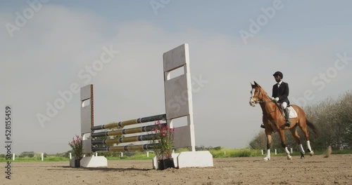 African American man jumping an obstacle with his Dressage horse