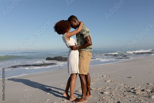 Happy couple embracing each other on the beach