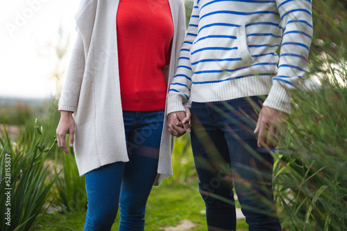 Young couple holding hands in the garden