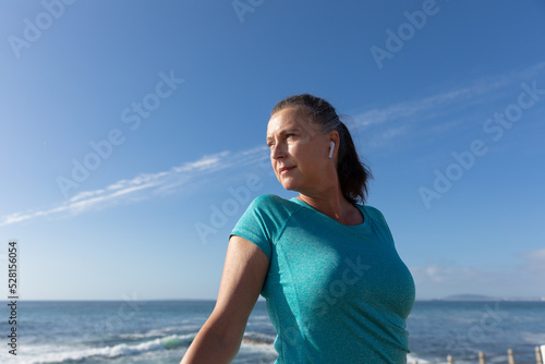 Female jogger relaxing on seaside