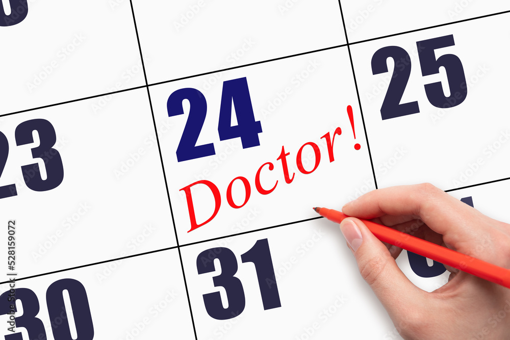 24th day of the month. Hand writing text DOCTOR on calendar date. 24th day of the month. Hand writing text DOCTOR on calendar date.