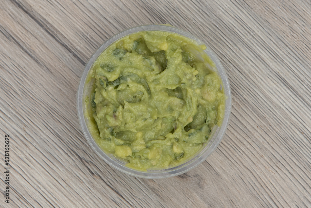 Overhead view of authentic Mexican flavor side dish appetizer of guacamole to complete the dinner meal Overhead view of authentic Mexican flavor side dish appetizer of guacamole to complete the dinner meal