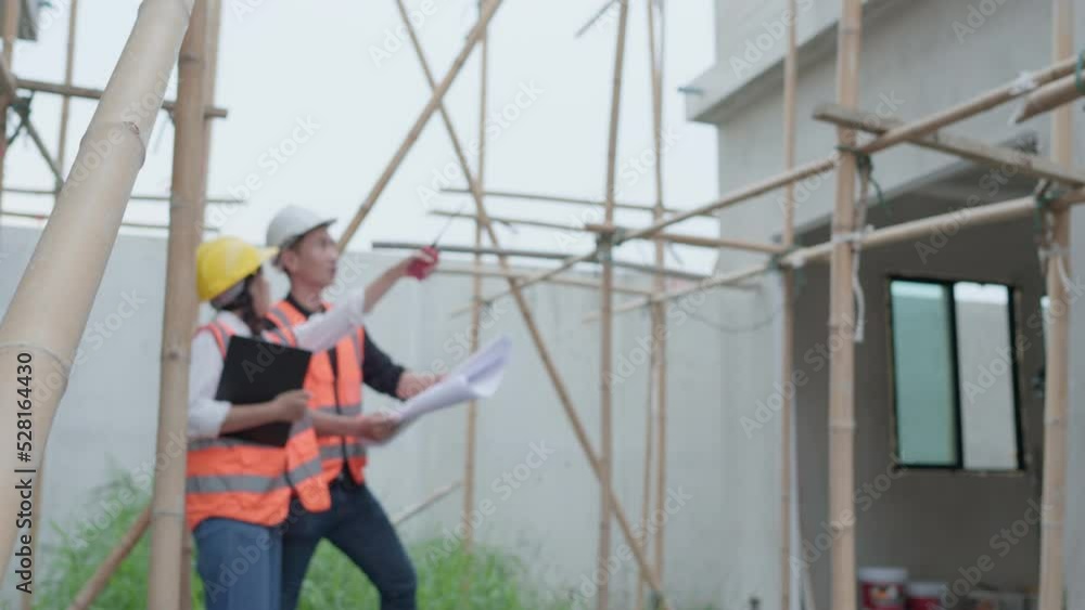 custom made wallpaper toronto digitalAsian woman civil engineer or Architect, inspector with contractor, foreman or worker wear safety helmet. Colleagues discussing, meeting about construction building project on site.