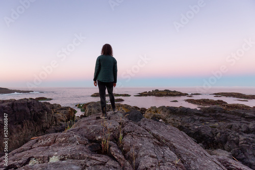 Adventurous Women Standing and Looking out to Ocean in Canadian Nature at Sunrise. Ancient Cedars Loop Trail. Ucluelet, British Columbia, Canada. Adventure Travel.