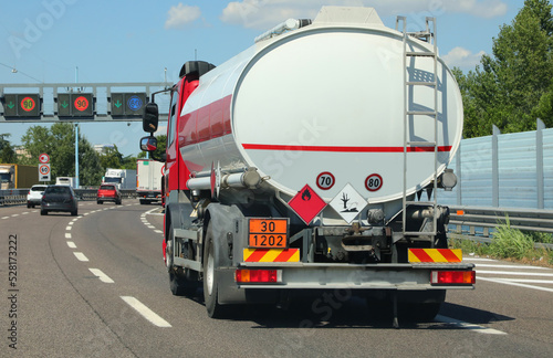 tanker truck in the busy street for transporting flammable material photo