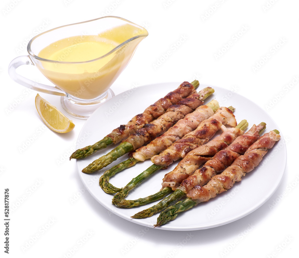 Healthy food - Asparagus wrapped with bacon and spices on a plate isolated on white background Healthy food - Asparagus wrapped with bacon and spices on a plate isolated on white background