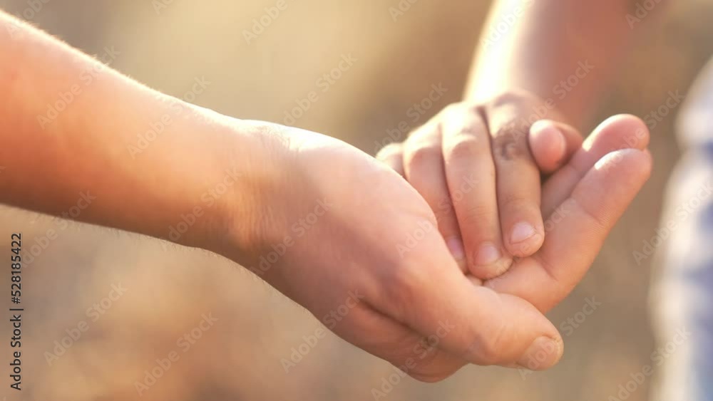 mother holds the hand of a newborn. close-up of a children hand. takes care of happy family medicine concept. newborn baby holding mom's hand close-up. mom takes care of baby outdoors lifestyle mother holds the hand of a newborn. close-up of a children hand. takes care of happy family medicine concept. newborn baby holding mom's hand close-up. mom takes care of baby outdoors lifestyle