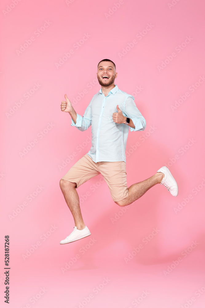 man in summer clothes jumping on pink background. man in summer clothes jumping on pink background.