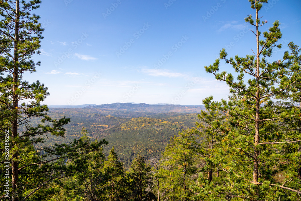 Fototapeta premium Beautiful view from the Sudovaya mountain to Inzer rocks, Yamantau mountain, Iremel mountain. Russia, South Ural, Bashkortostan Republic, Beloretsky district, near the Tirlyansky village.