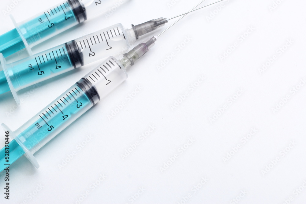 Medical syringe on a white background. A syringe for injection. The concept of health and beauty Medical syringe on a white background. A syringe for injection. The concept of health and beauty