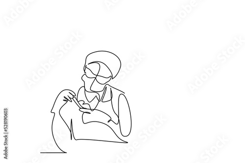 a young female scientist fully equipped holding and examining a test tube