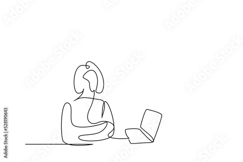one young beautiful serious confident woman posing standing near laptop computer with crossed arms