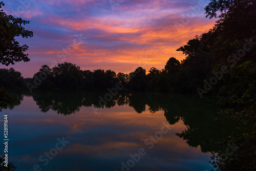 Pond sunrise with golden clouds