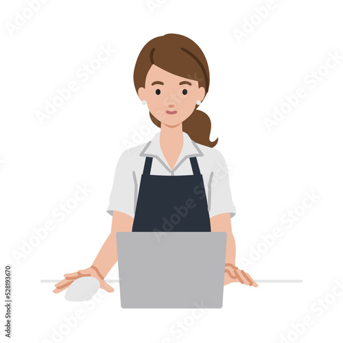 デスクで座ってPCを使っている店員の女性