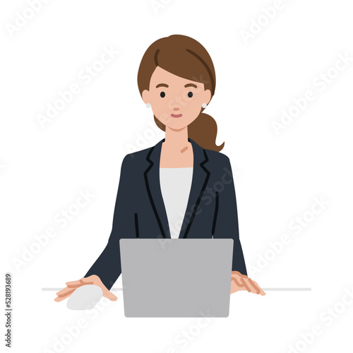 デスクで座ってPCを使っているスーツの女性