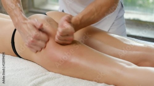 Anti-cellulite massage in the spa salon. The masseur massages the buttocks, hips and legs. Relaxing treatment. Slimming and body shaping. Healthy body and skin. Self love care