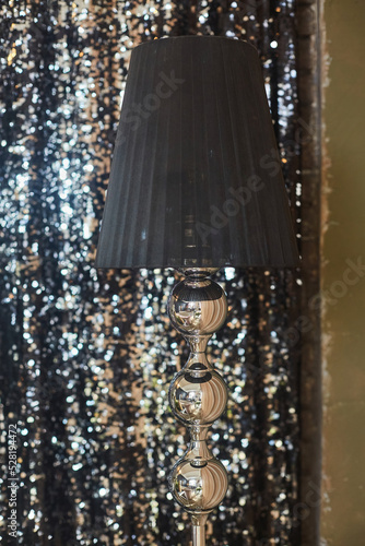 A beautiful floor lamp with a lampshade as a decoration for interior design.