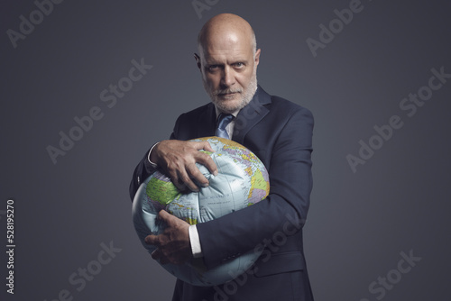 Slika na platnu Greedy corporate businessman crushing and exploiting earth