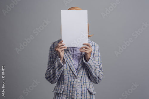 Woman hiding behind a sign photo